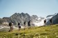 Summer hikers walking to a glacier in the alps.